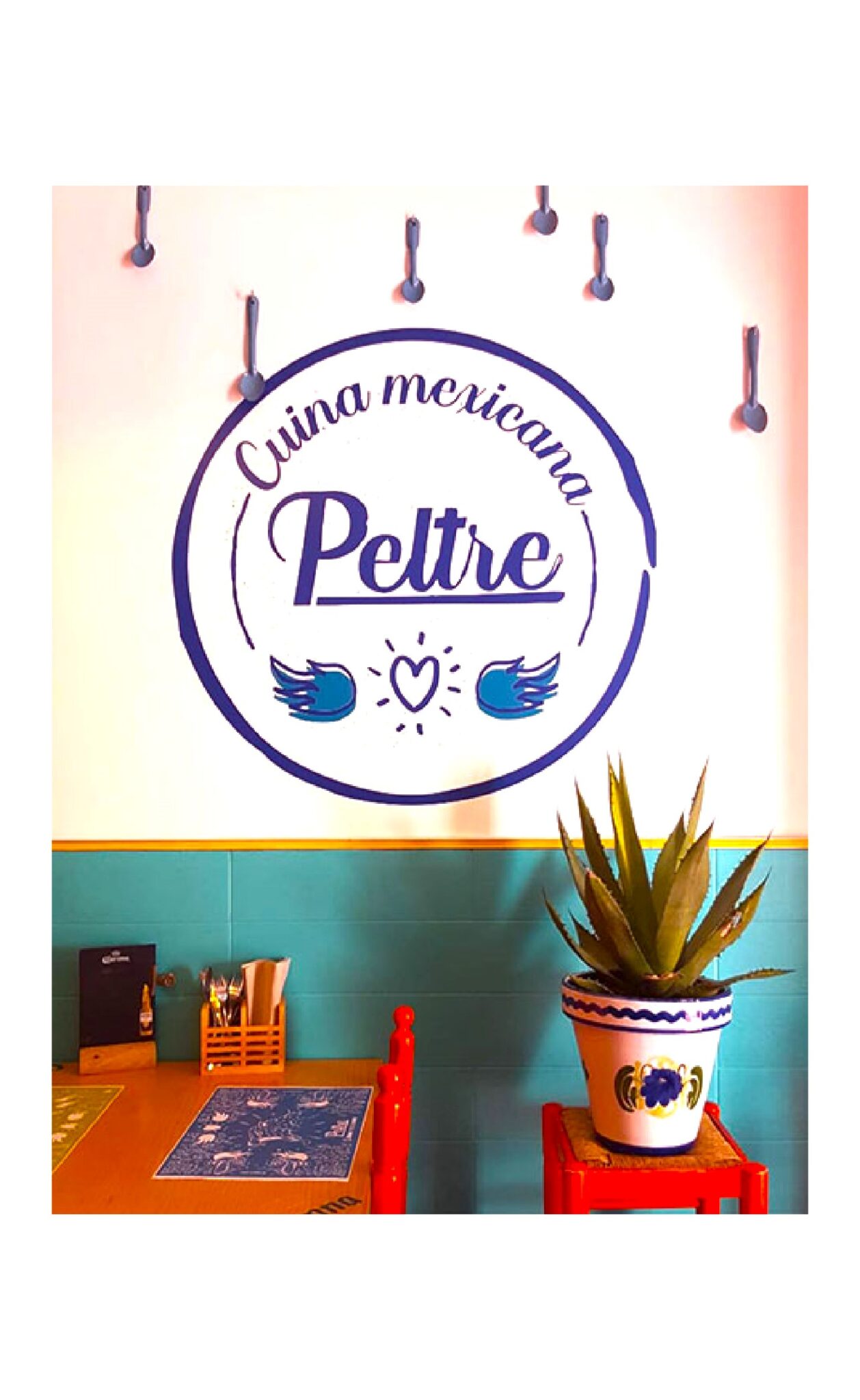 Cocina mexicana Peltre restaurant wall sign and plant
