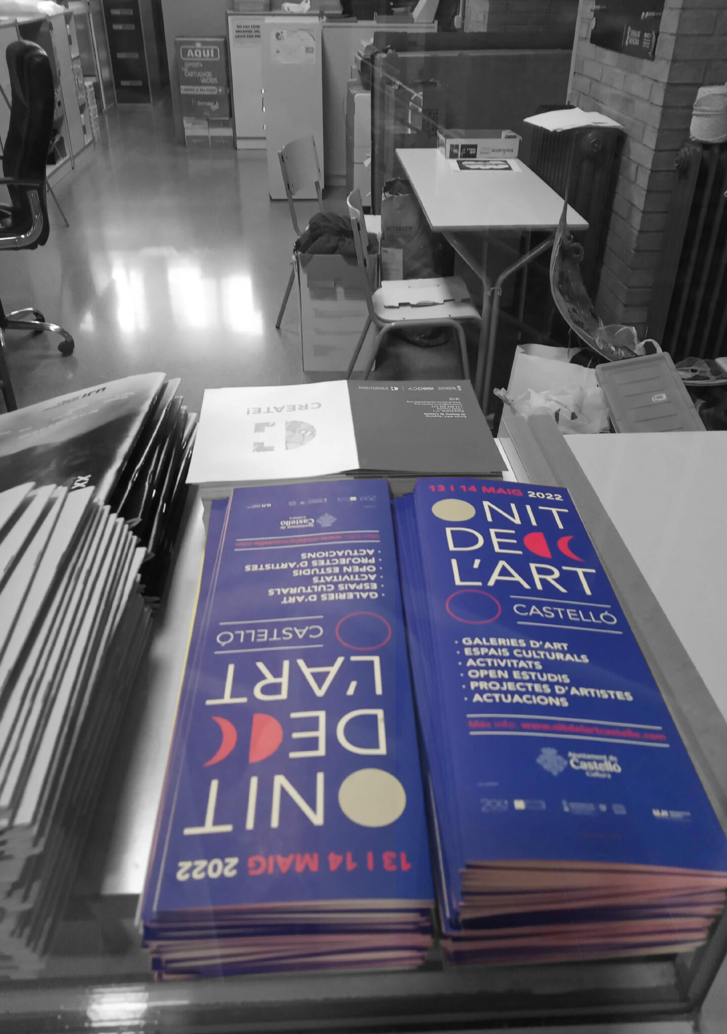 Stacks of art event flyers on table