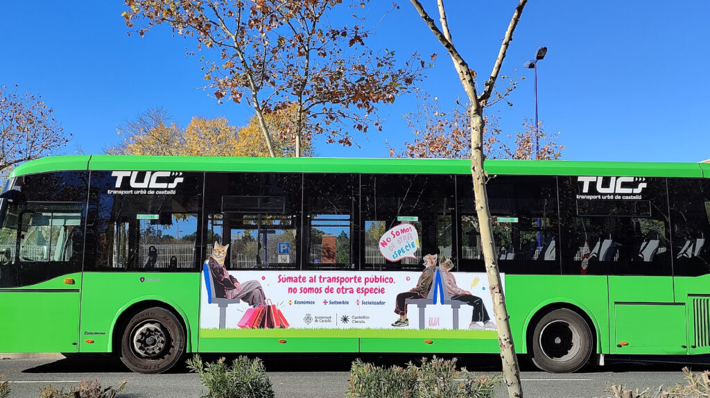 Green city bus with public transport advertisement